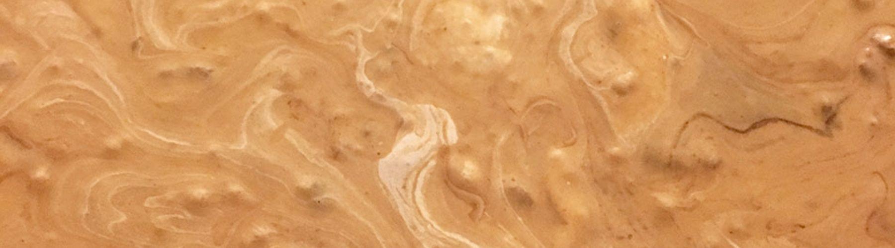 Close-up of chocolate and marshmallow swirls in a pan of uncut peanut butter fudge.